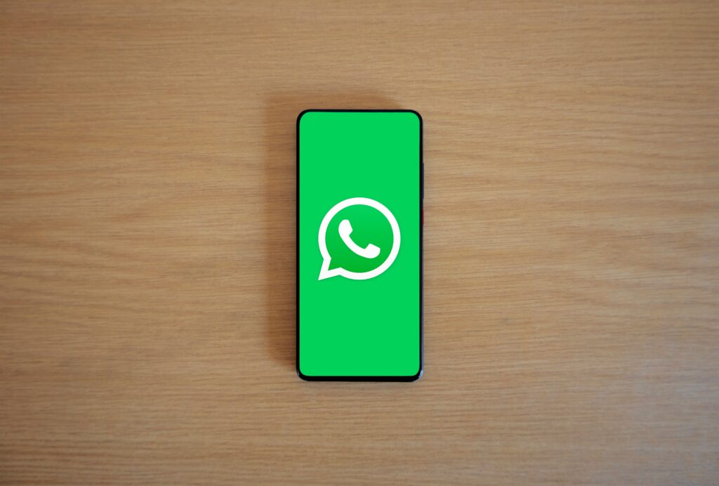 Pessoa a usar o WhatsApp no smartphone, representando como configurar ChatGPT e Claude no WhatsApp em 2026